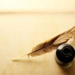 Envelope with inkwell and feather